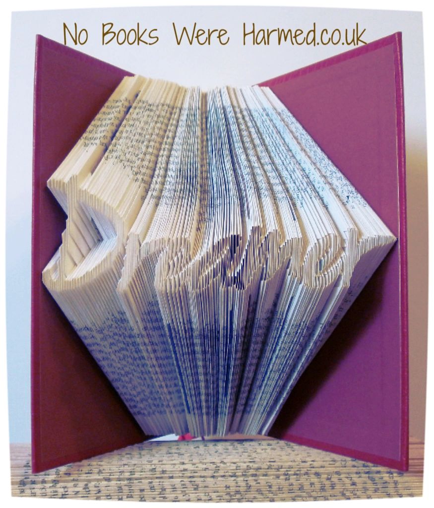 Hand-folded book art titled 'Dreamer', showcasing intricate page folds from vintage books, creating a unique decorative piece.