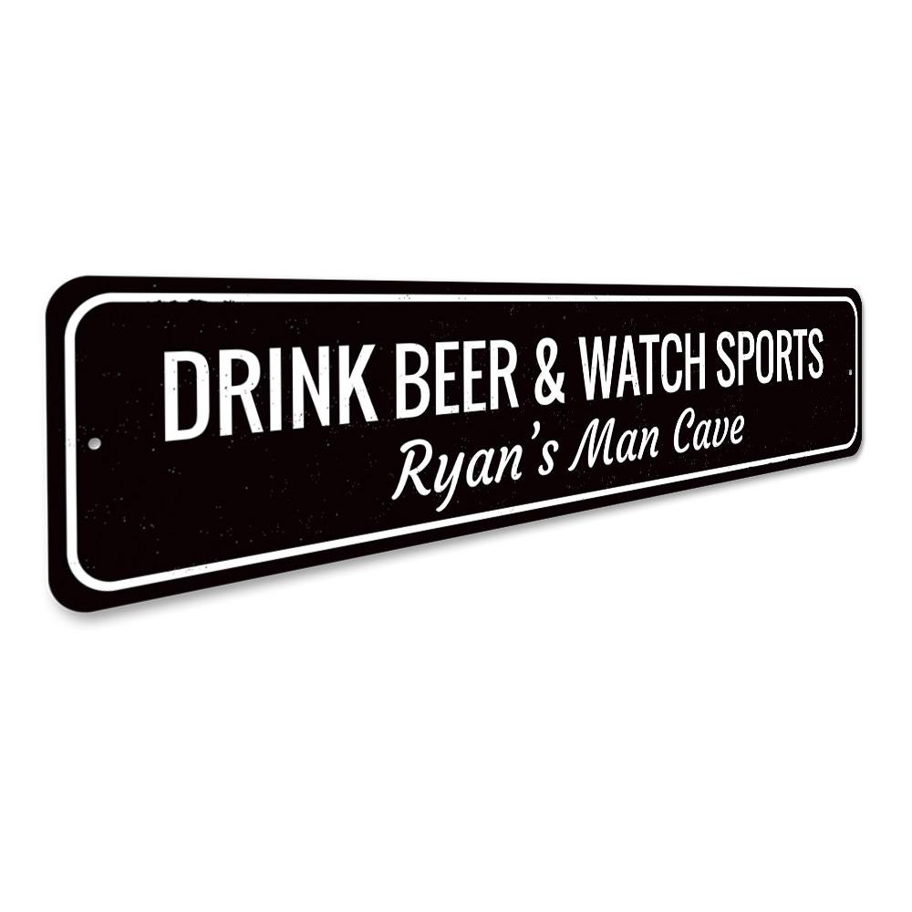 A decorative metal sign that reads 'Drink Beer & Watch Sports', perfect for man caves and game rooms, showcasing quality craftsmanship.