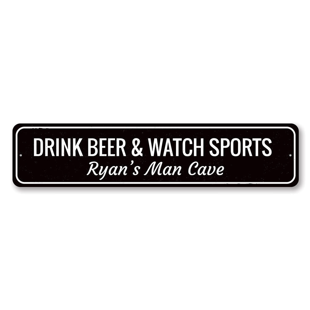 A decorative metal sign that reads 'Drink Beer & Watch Sports', perfect for man caves and game rooms, showcasing quality craftsmanship.