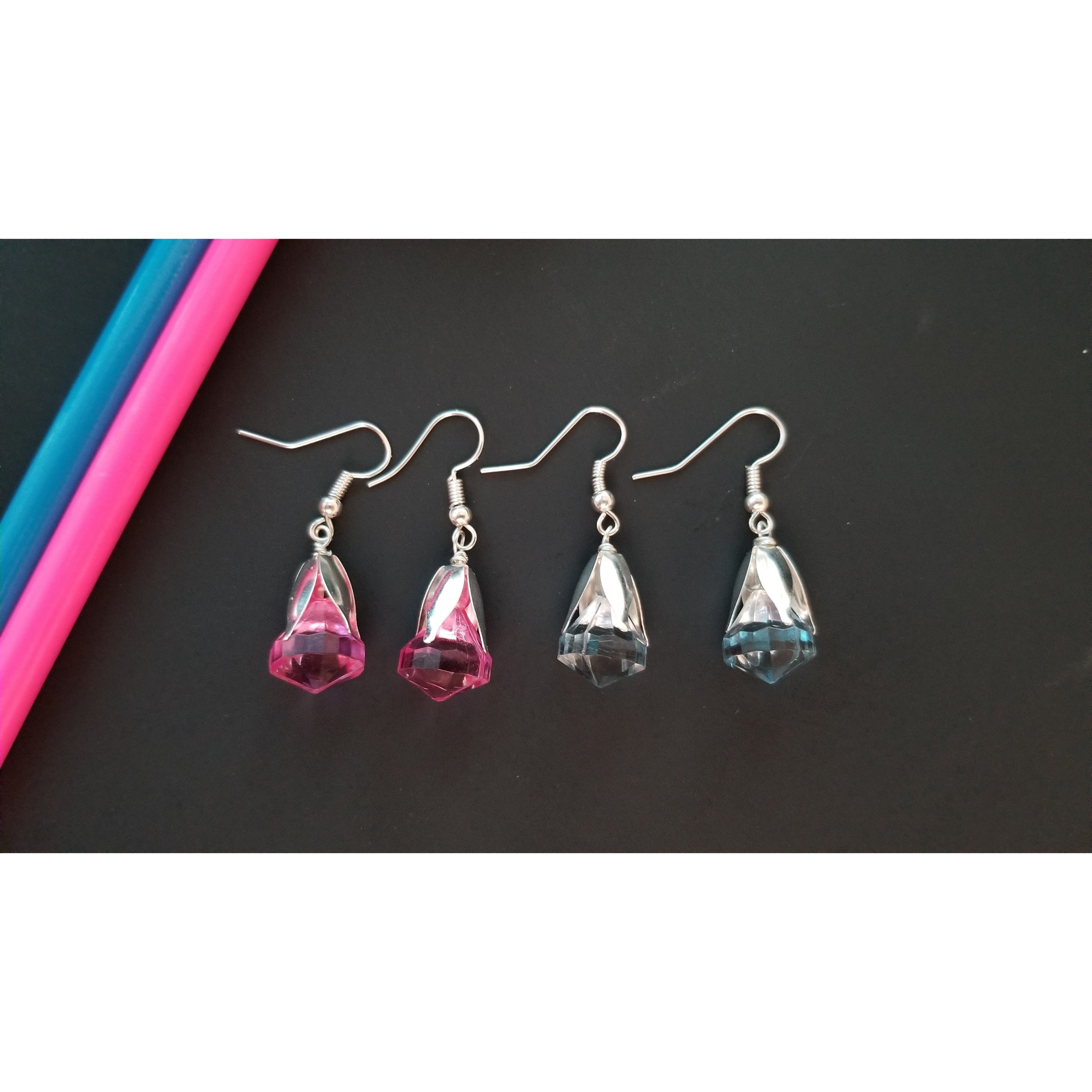 Elegant drop earrings featuring translucent pink and blue beads, showcasing their unique design and colors.