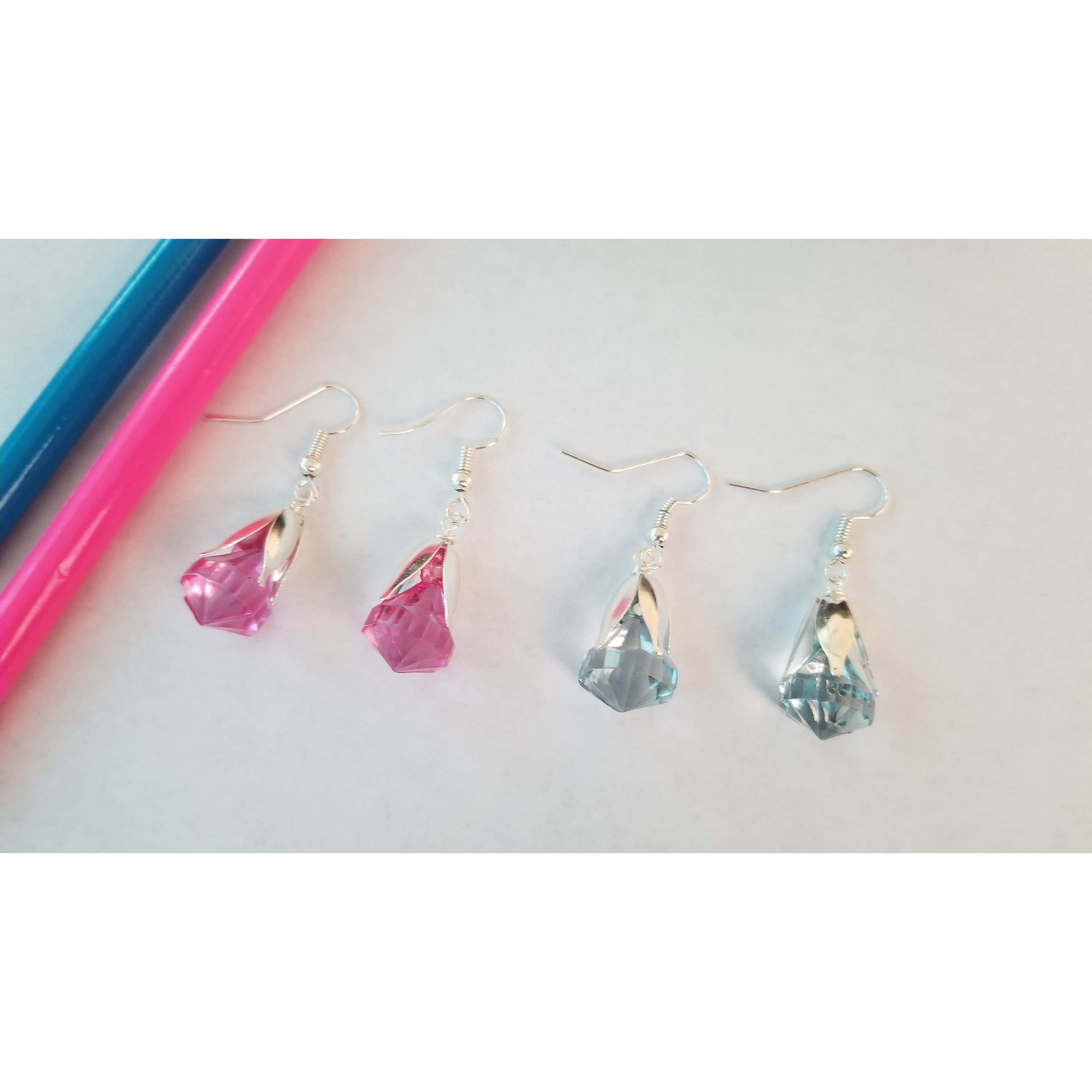 Elegant drop earrings featuring translucent pink and blue beads, showcasing their unique design and colors.