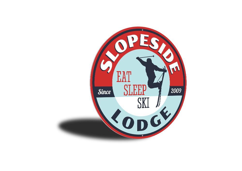 Eat Sleep Ski Circle Sign made of durable aluminum, featuring a circular design with ski-themed graphics, perfect for lodge decor.