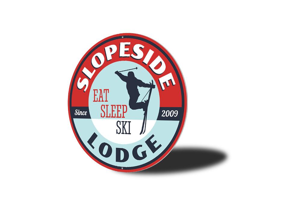 Eat Sleep Ski Circle Sign made of durable aluminum, featuring a circular design with ski-themed graphics, perfect for lodge decor.