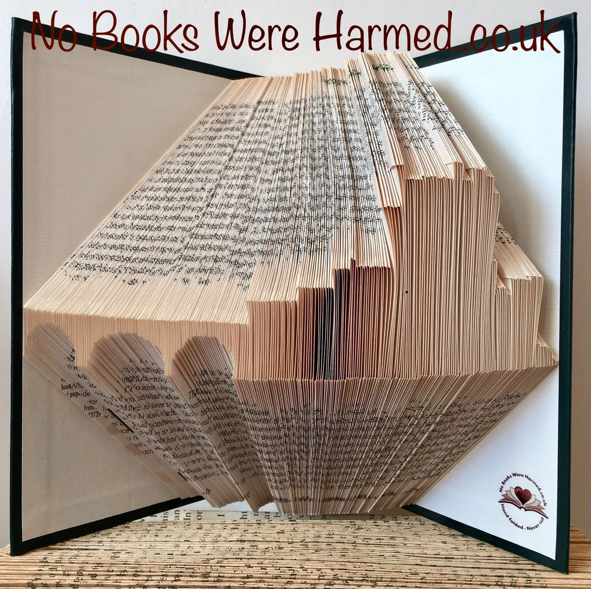 Handcrafted Eilean Donan book art made from vintage books, showcasing intricate folds and unique design inspired by the Scottish castle.