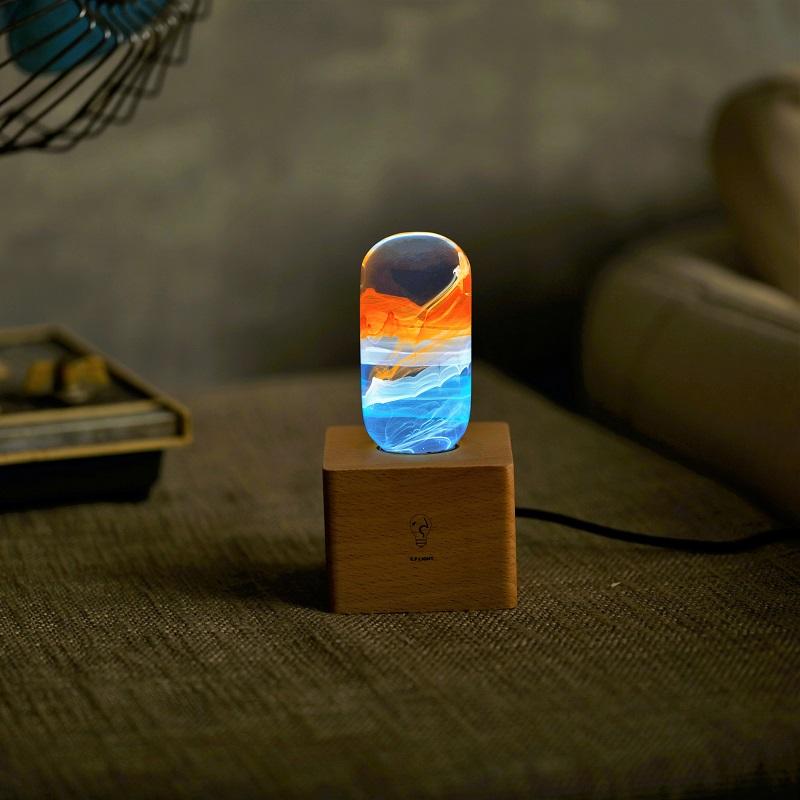 EP LIGHT 4-Pack LED Lights featuring unique handcrafted designs in eco-friendly resin, showcasing various colors and a wooden base.