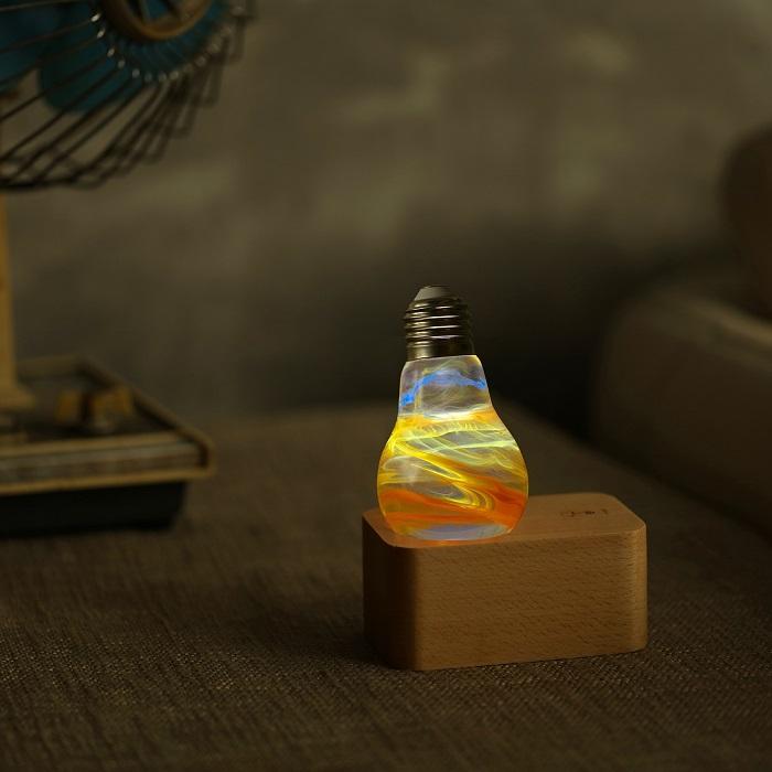EP LIGHT 4-Pack LED Lights featuring unique handcrafted designs in eco-friendly resin, showcasing various colors and a wooden base.