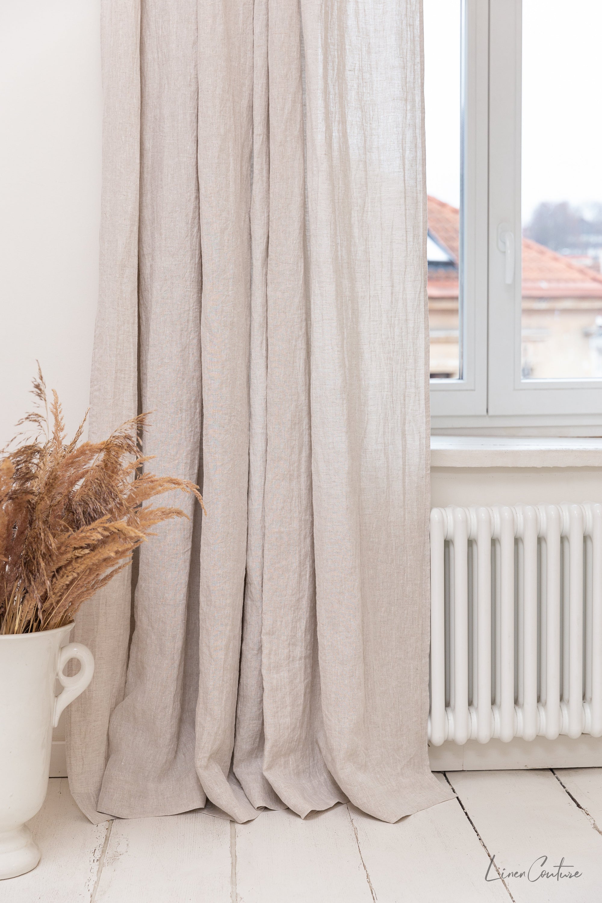 Extra wide white linen curtain panel with tab top, showcasing its elegant design and soft texture.
