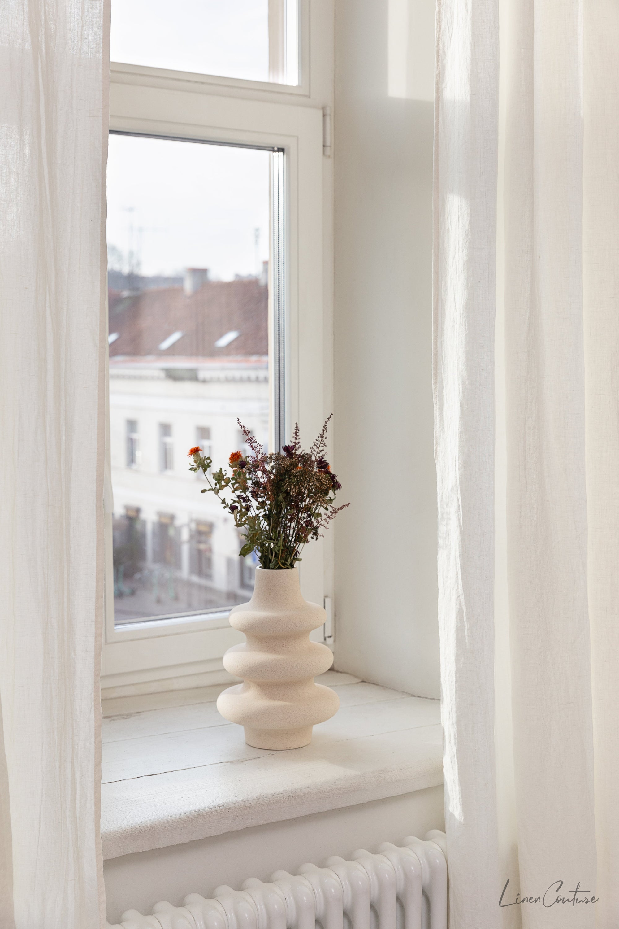 Extra wide white linen curtain panel with tab top, showcasing its elegant design and soft texture.