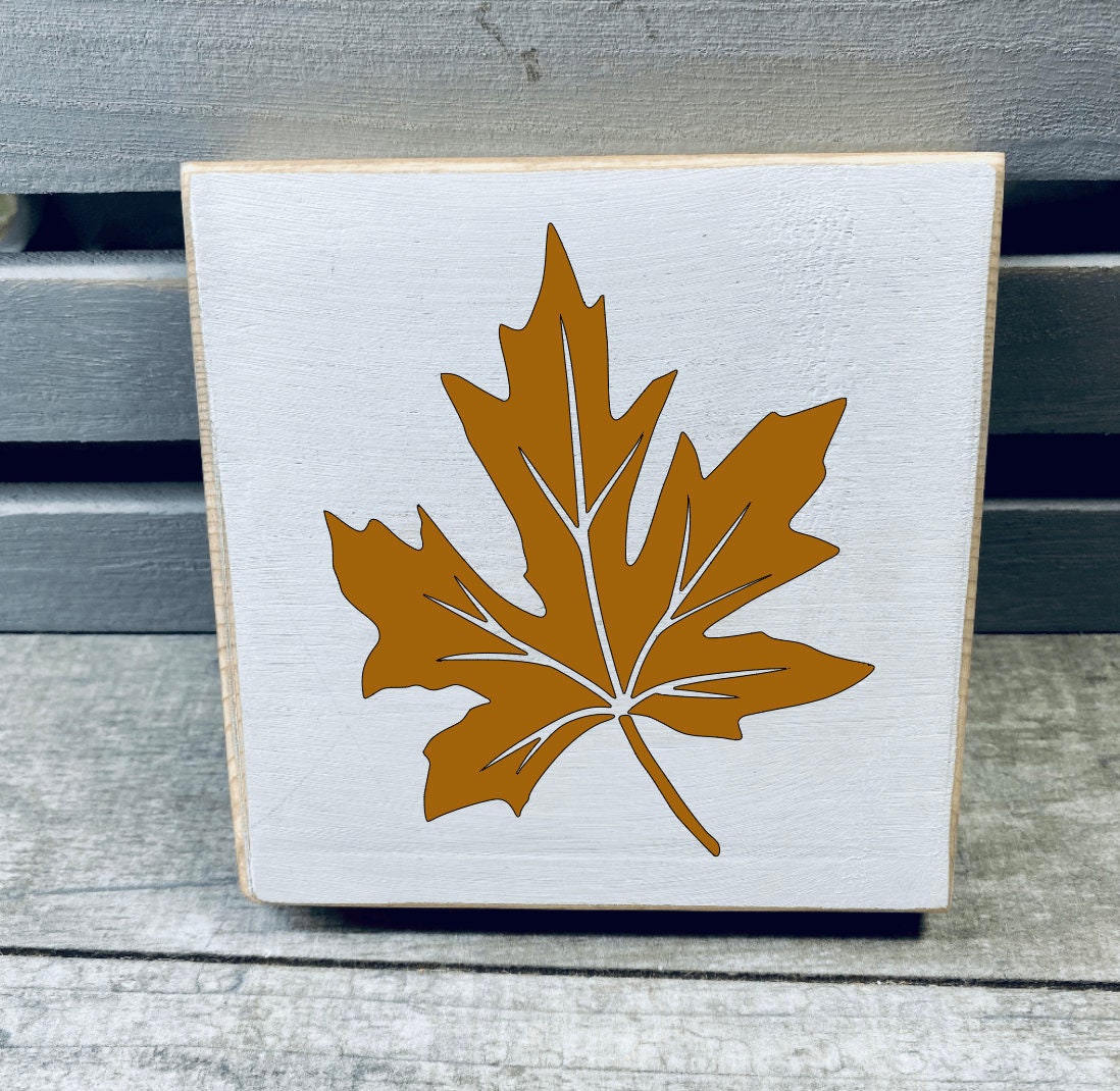 A set of three hand-painted mini wood signs featuring fall leaves and an acorn, perfect for tiered tray decor.