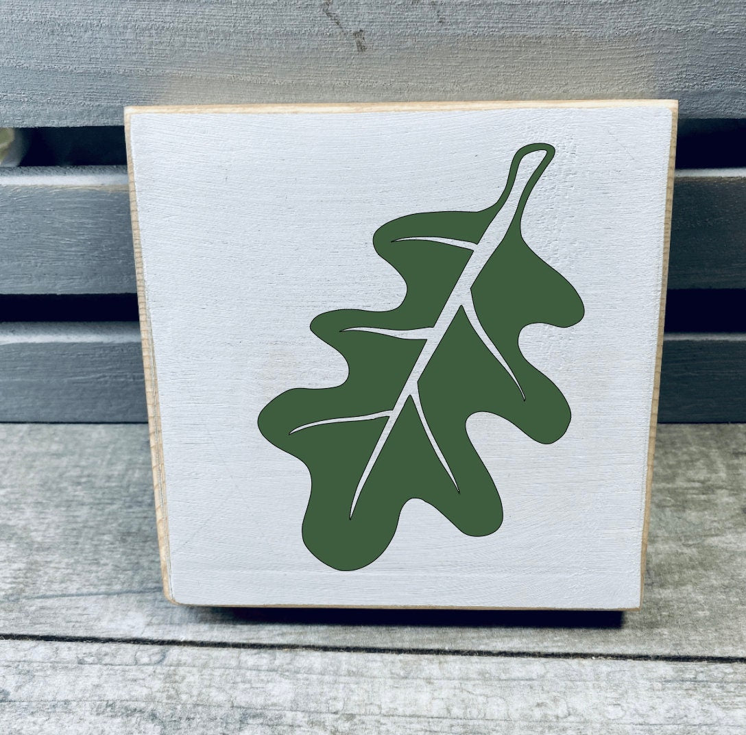 A set of three hand-painted mini wood signs featuring fall leaves and an acorn, perfect for tiered tray decor.