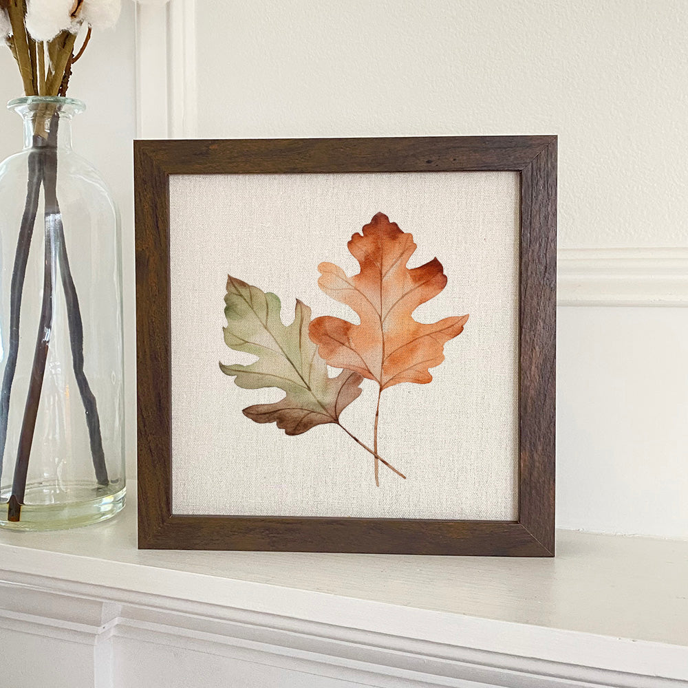 Framed sign featuring fall oak leaves in a stylized wood frame, available in walnut or white-washed finish.
