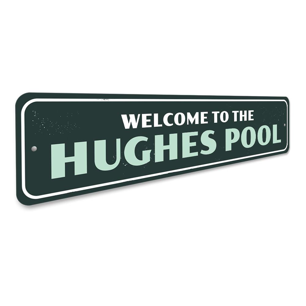 A decorative Family Pool Welcome Sign made of durable aluminum, featuring customizable text and pre-drilled holes for easy mounting.