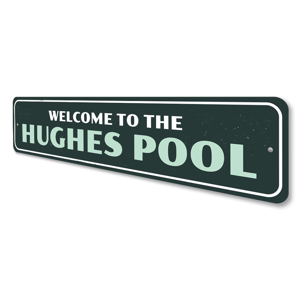 A decorative Family Pool Welcome Sign made of durable aluminum, featuring customizable text and pre-drilled holes for easy mounting.