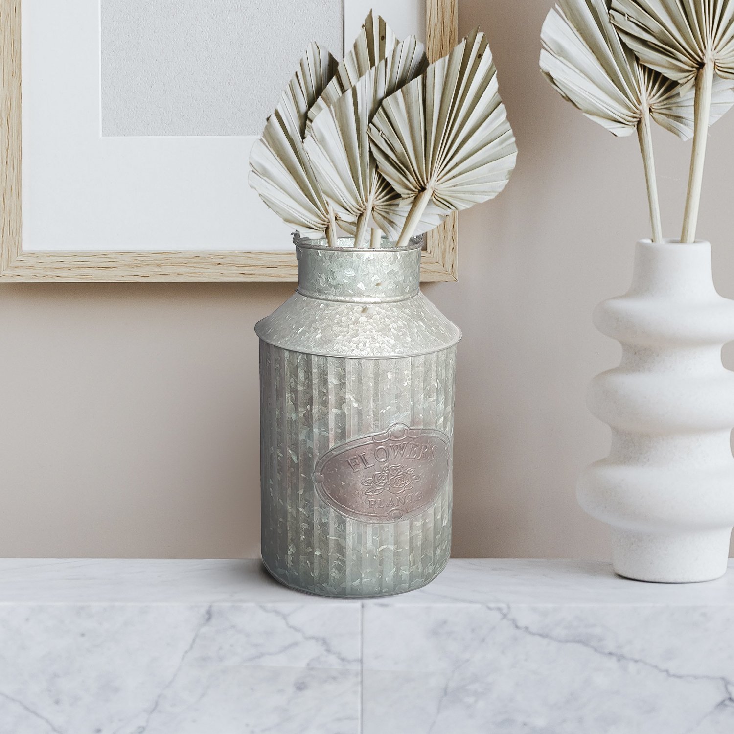 A rustic farmhouse style metal can for flowers and plants, featuring a handle and a vintage galvanized steel finish, perfect for home decor.