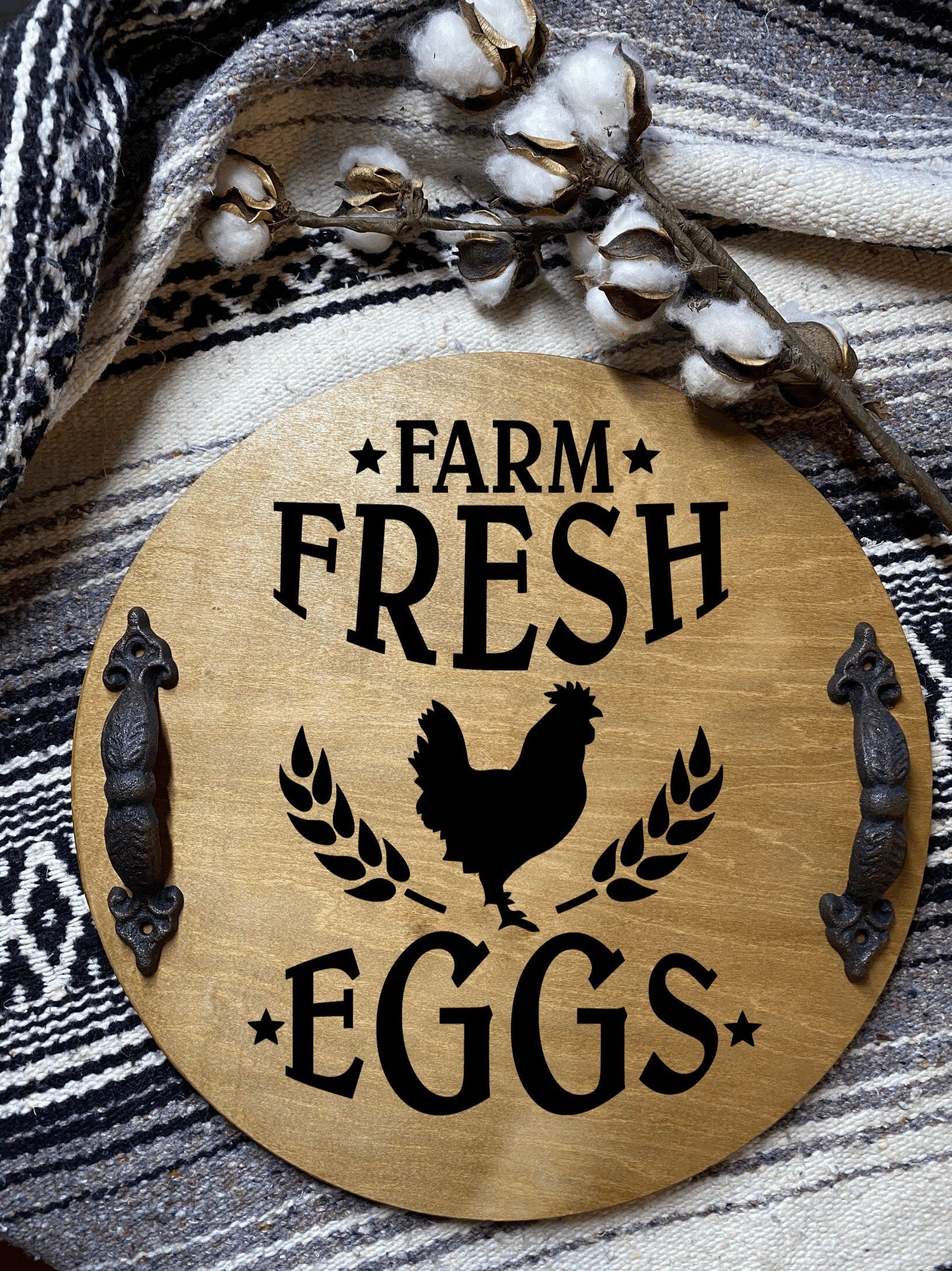 Handmade wooden farmhouse tray with rustic pine finish and cast iron handles, displaying the sentiment 'Farm Fresh Eggs'.