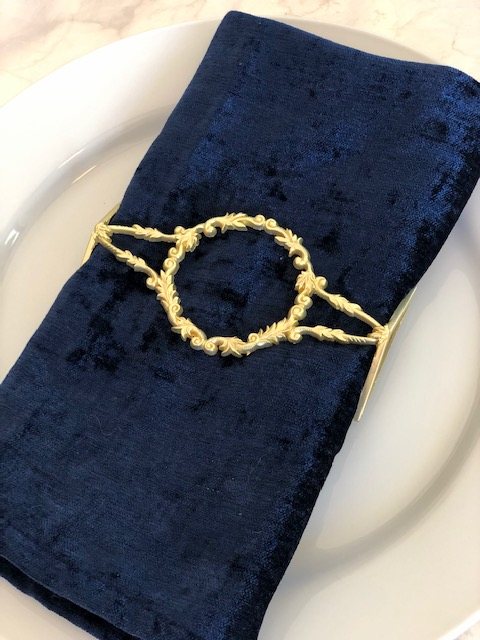 Elegant matte gold filigree napkin wrap showcasing intricate design, perfect for enhancing table settings.