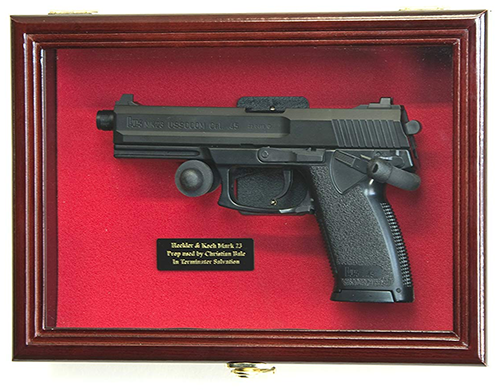 Flag Connections Single Pistol Display Case made of solid beech hardwood with a UV-protected acrylic door, showcasing a firearm elegantly mounted on a wall.