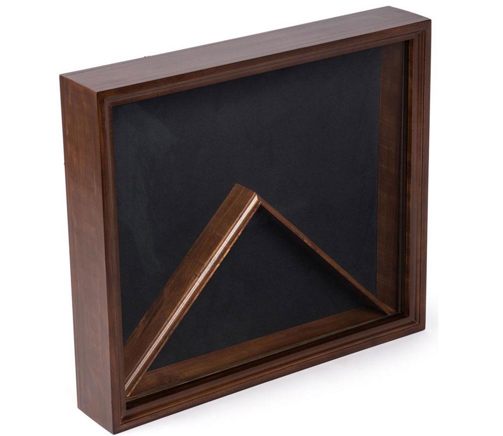 Elegant flag display case with glass front and black velvet backing showcasing military medals and mementos.