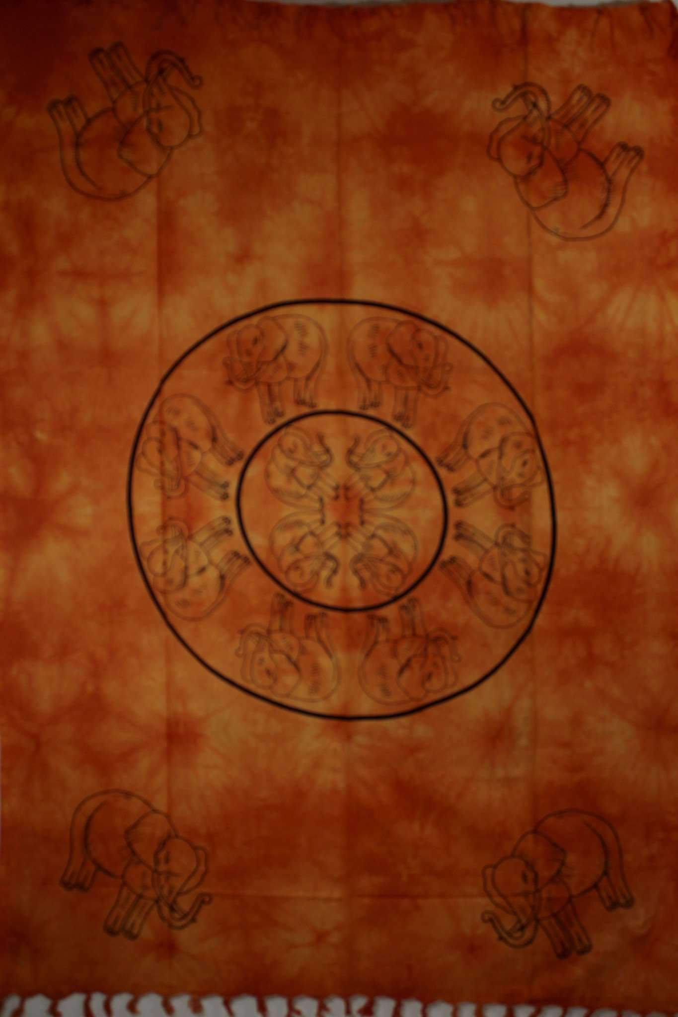 Folk Style Elephant Tie Dye Tapestry featuring colorful elephants on a saffron tie dye background with decorative tassels.