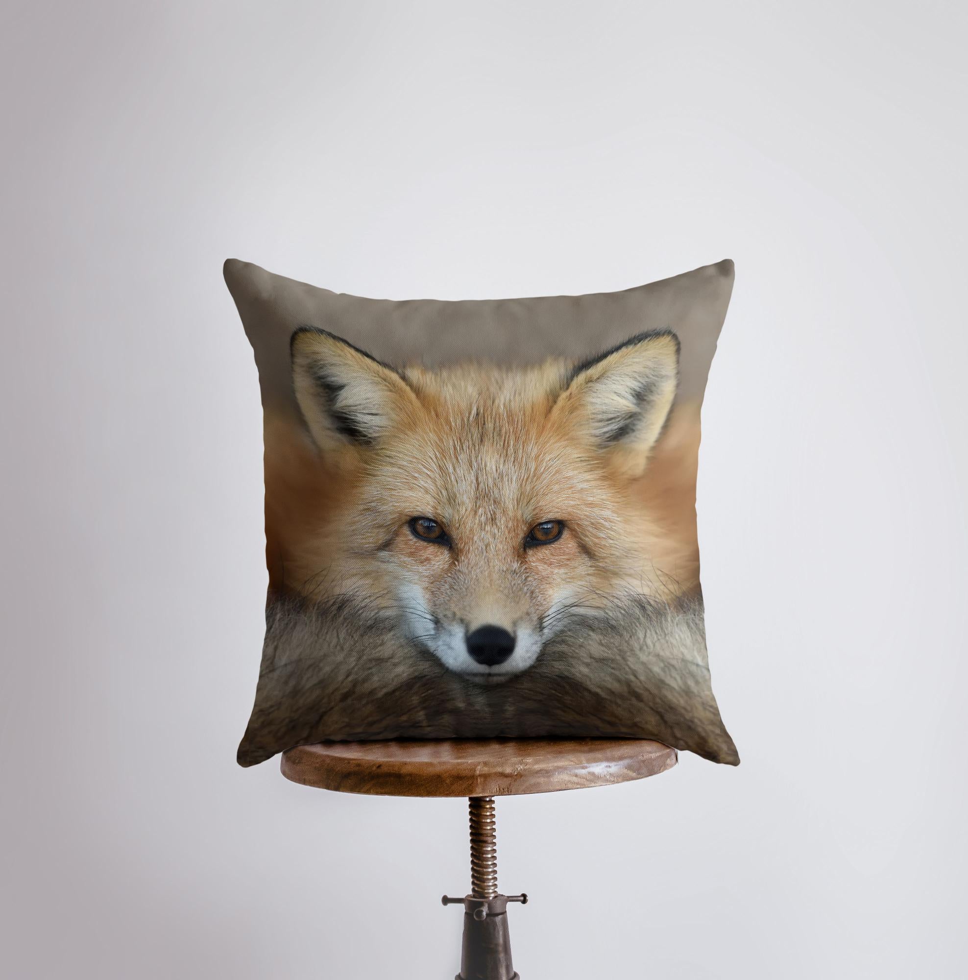 A beautifully crafted pillow cover featuring a close-up photograph of a curious fox, set against a light beige background with a concealed zipper.