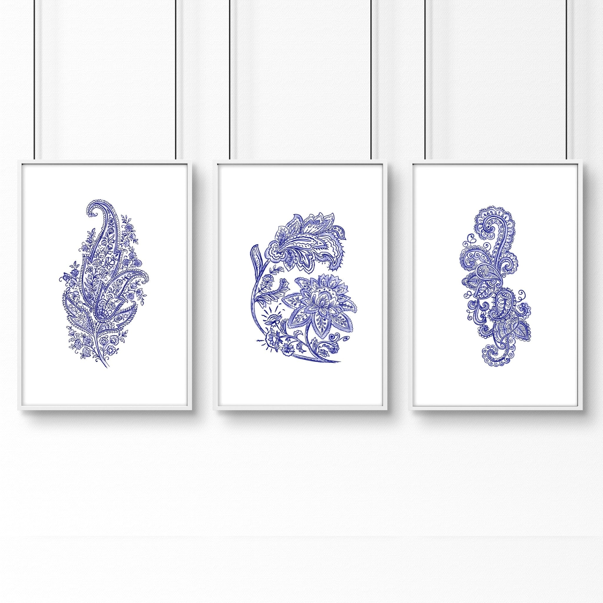 Set of 3 framed wall art prints featuring hand-drawn paisley motifs in indigo blue, perfect for bohemian living room decor.