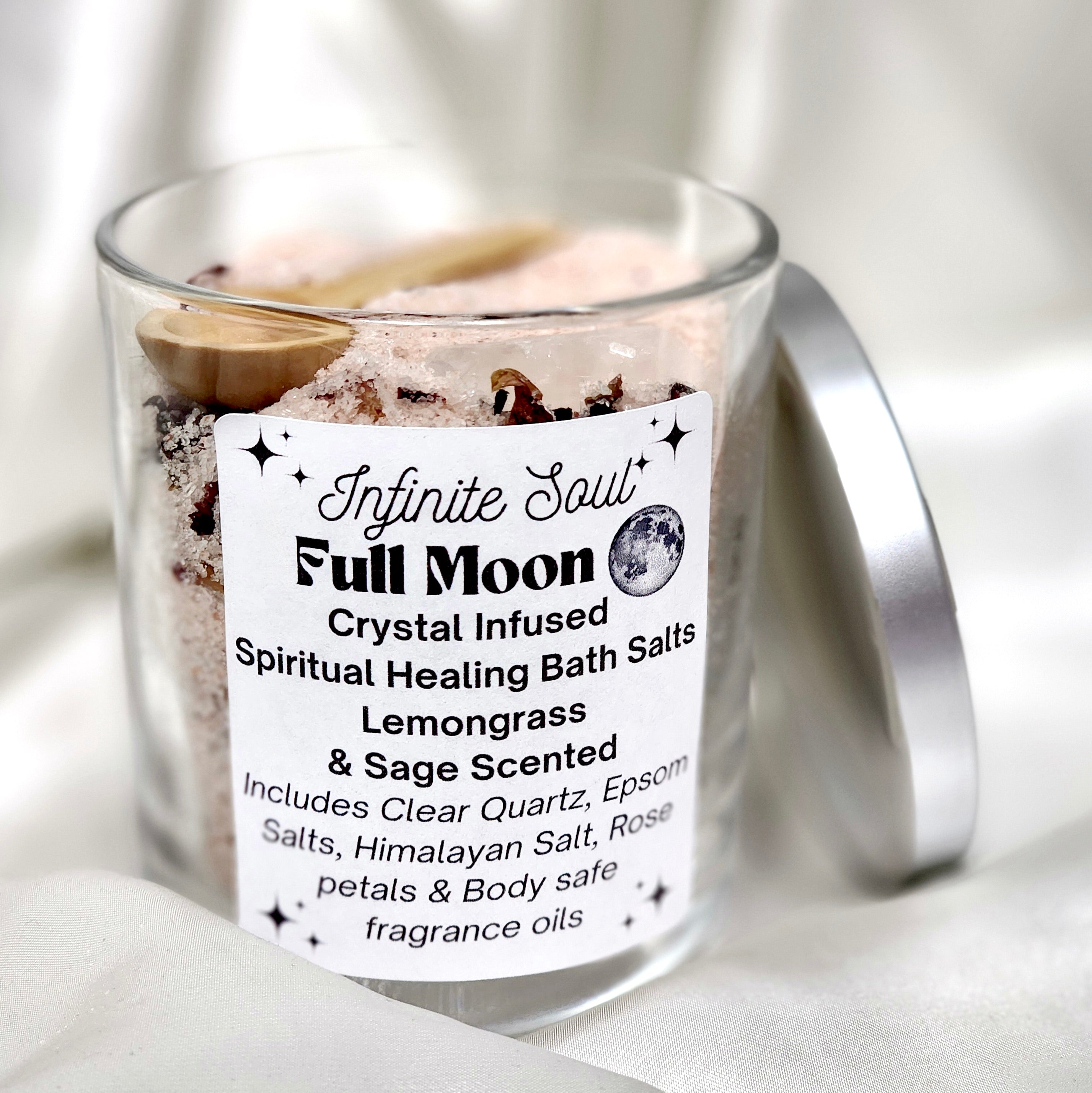 Full Moon Crystal Infused Bath Salts with lemongrass and sage scent, featuring natural ingredients like Epsom salts, rose petals, and a wooden spoon.
