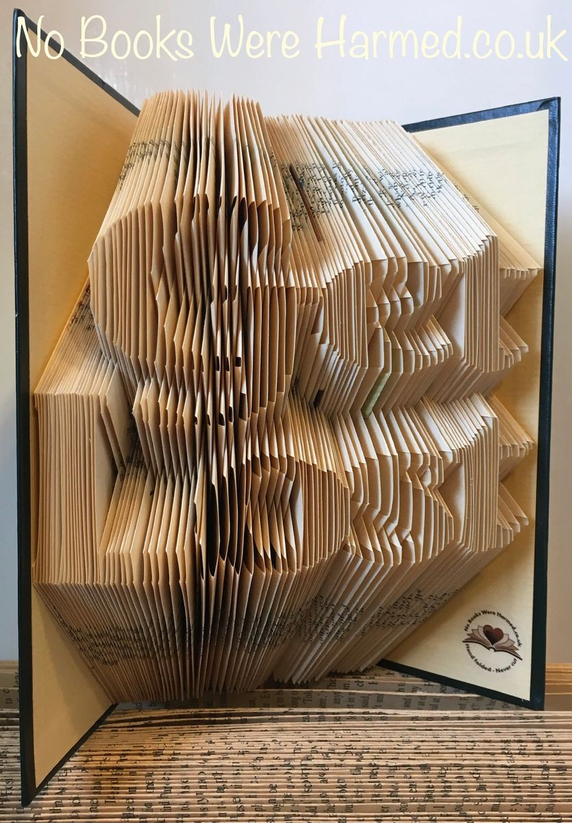 Hand-folded book art titled 'Get Lost in a Book', showcasing intricate designs from vintage pages.