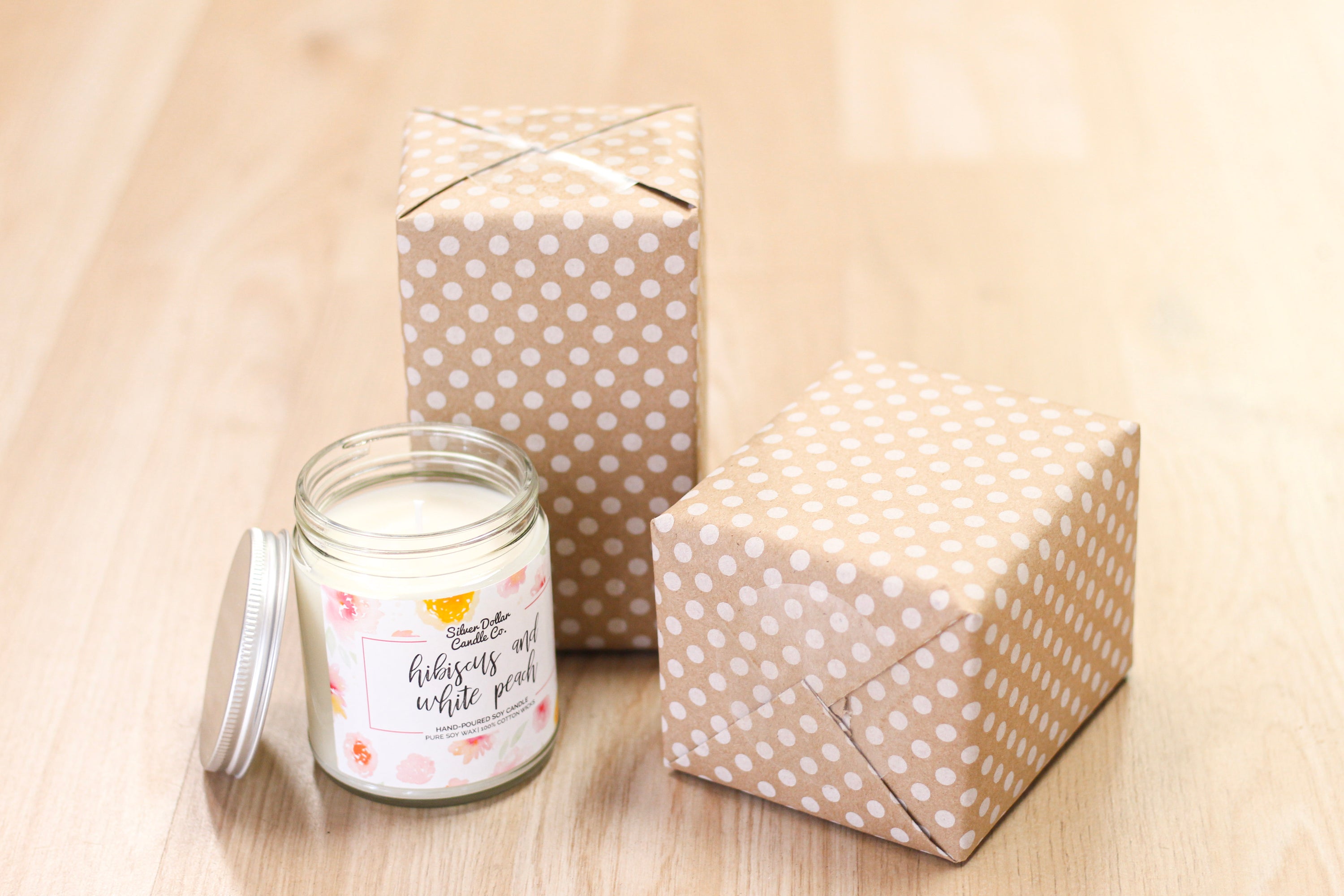 A beautifully wrapped candle in seasonal kraft paper, showcasing elegant designs.