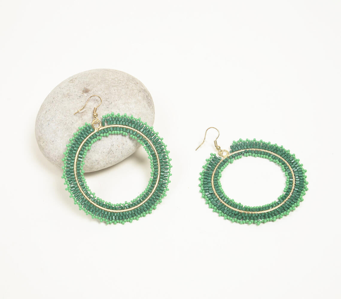 Elegant handmade green glass beaded loop dangle earrings showcasing intricate craftsmanship.