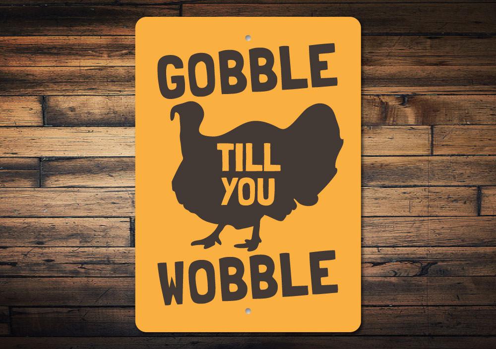 Gobble Till You Wobble Sign made of high-quality aluminum, featuring festive lettering and a charming design, perfect for home decor.