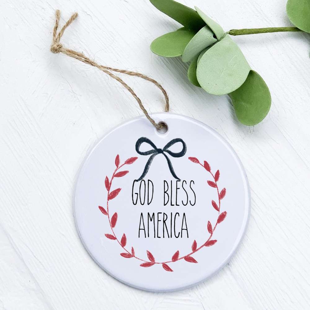 God Bless America Wreath ornament made of high-quality porcelain with a vibrant design, measuring 2.75 inches in diameter.