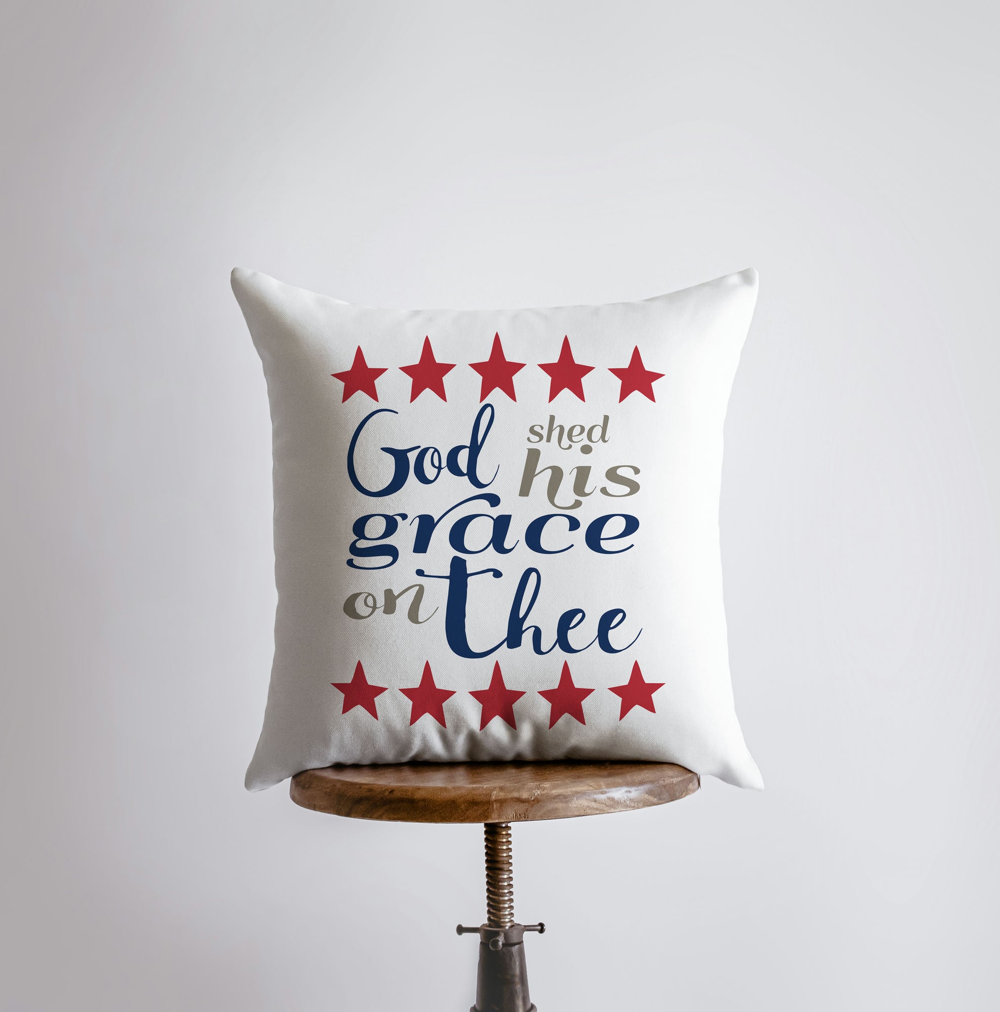 Handmade throw pillow featuring 'God Shed His Grace on Thee' design with red stars on the back, perfect for patriotic home decor.