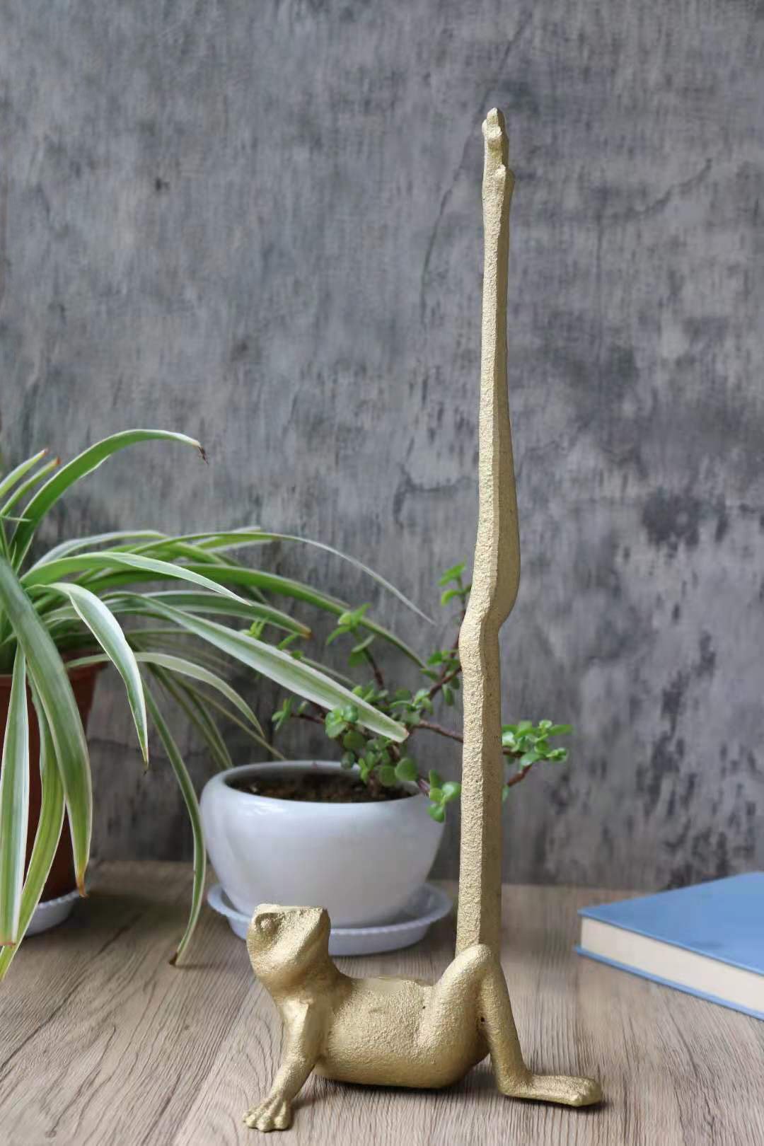 Gold Frog Paper Towel Holder made of cast iron, featuring a whimsical frog design with a hand brushed gold finish.