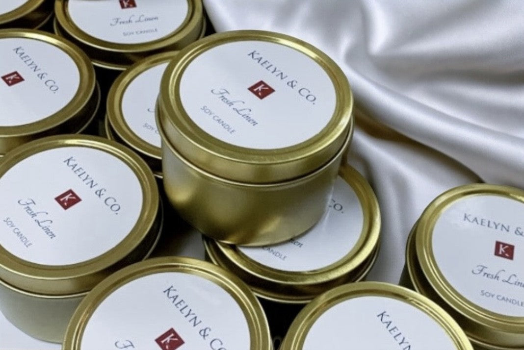 A luxurious Gold Travel Candle made from 100% soy wax, elegantly packaged and ready for travel, showcasing its sophisticated design and inviting fragrance.