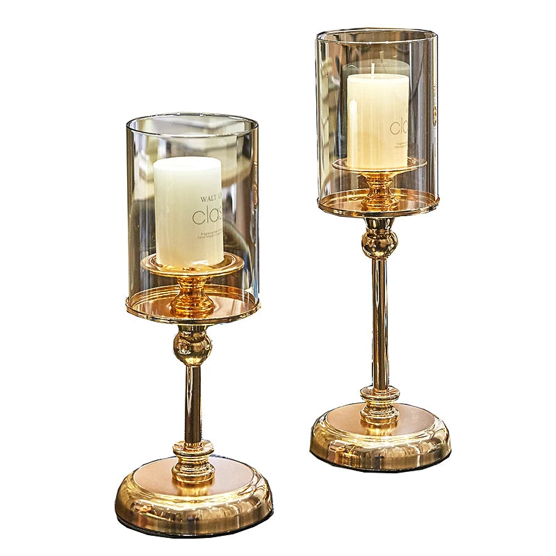 Elegant golden glass candle holders designed for pillar candles, showcasing a luxurious finish and reflective surface.