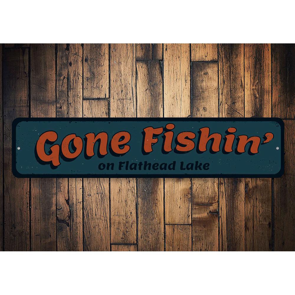 A decorative Gone Fishin sign made of high-quality aluminum, featuring a rustic design perfect for lakehouse decor.