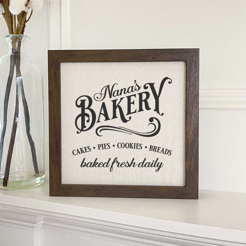Framed sign featuring a stylish wood frame with a linen-look background, perfect for home decor.