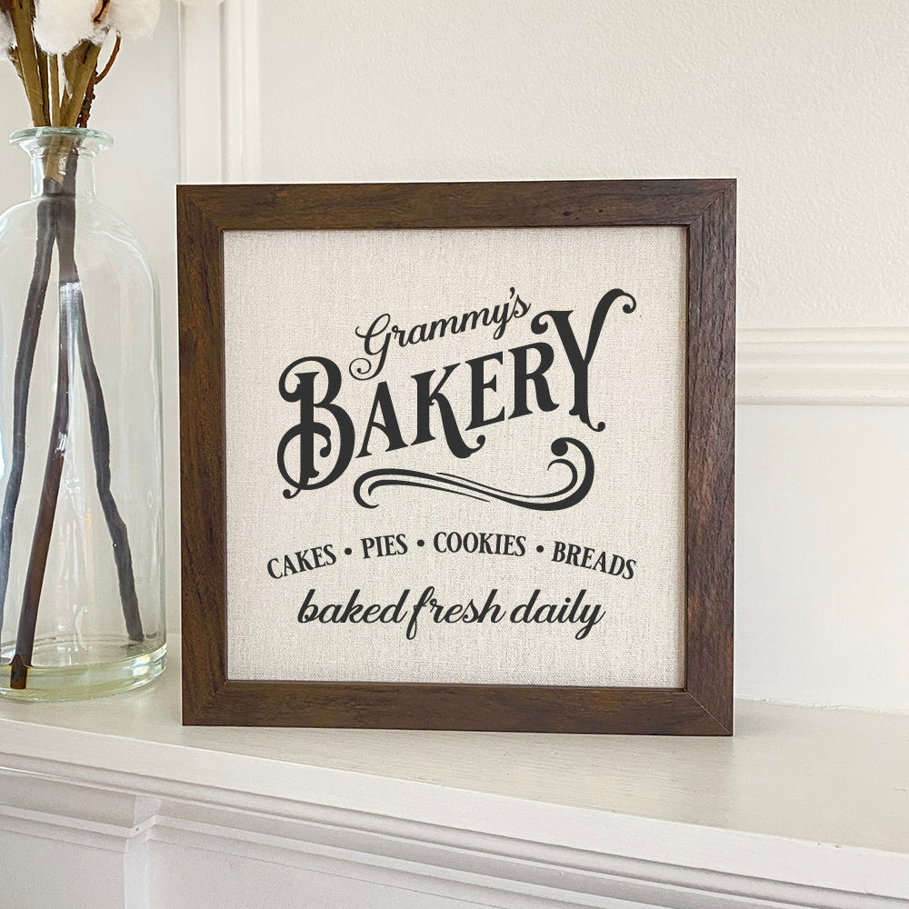 Framed sign featuring a stylish wood frame with a linen-look background, perfect for home decor.