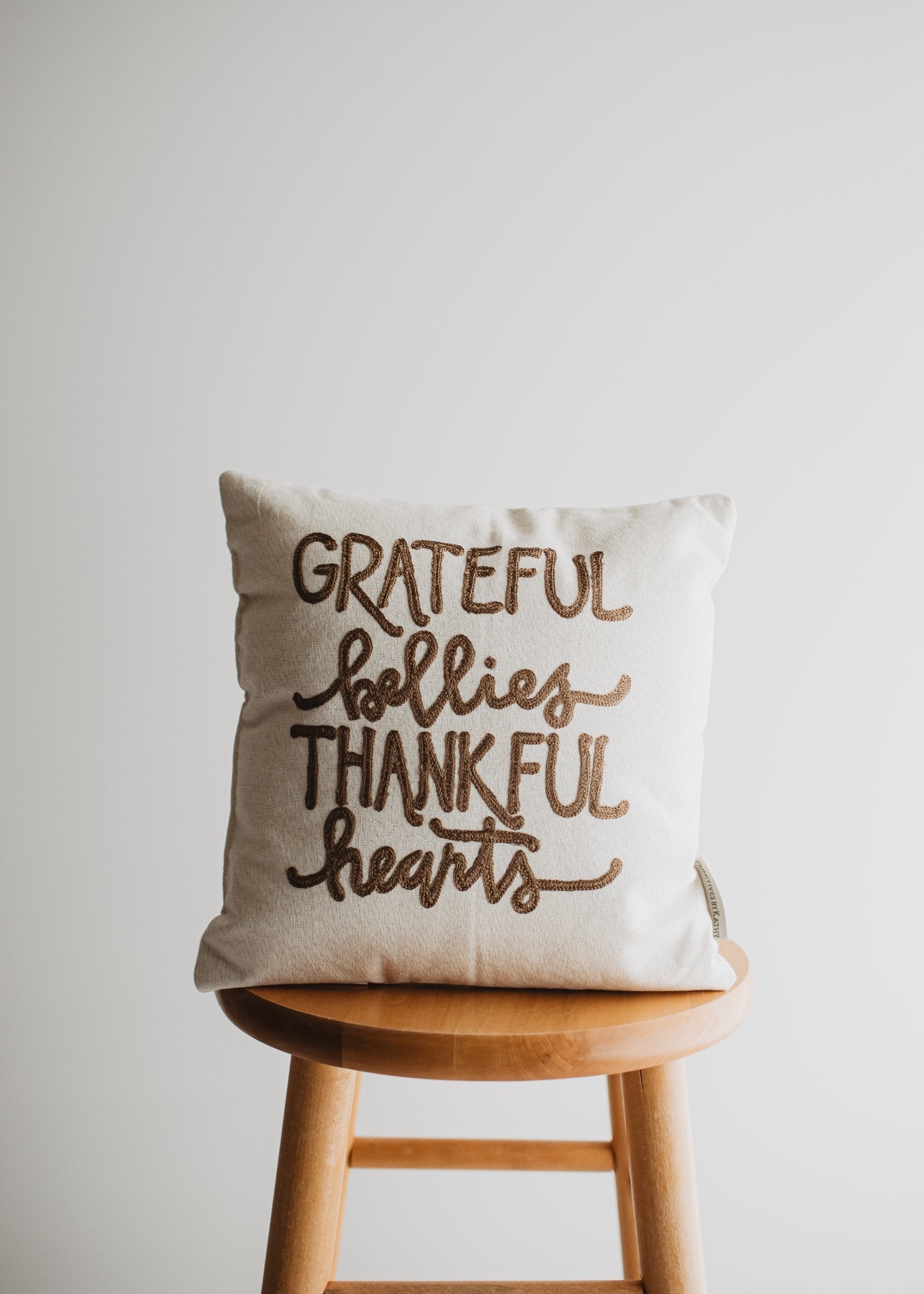 Grateful Bellies Thankful Hearts Pillow featuring embroidered lettering and gold shimmer back fabric, perfect for Thanksgiving decor.