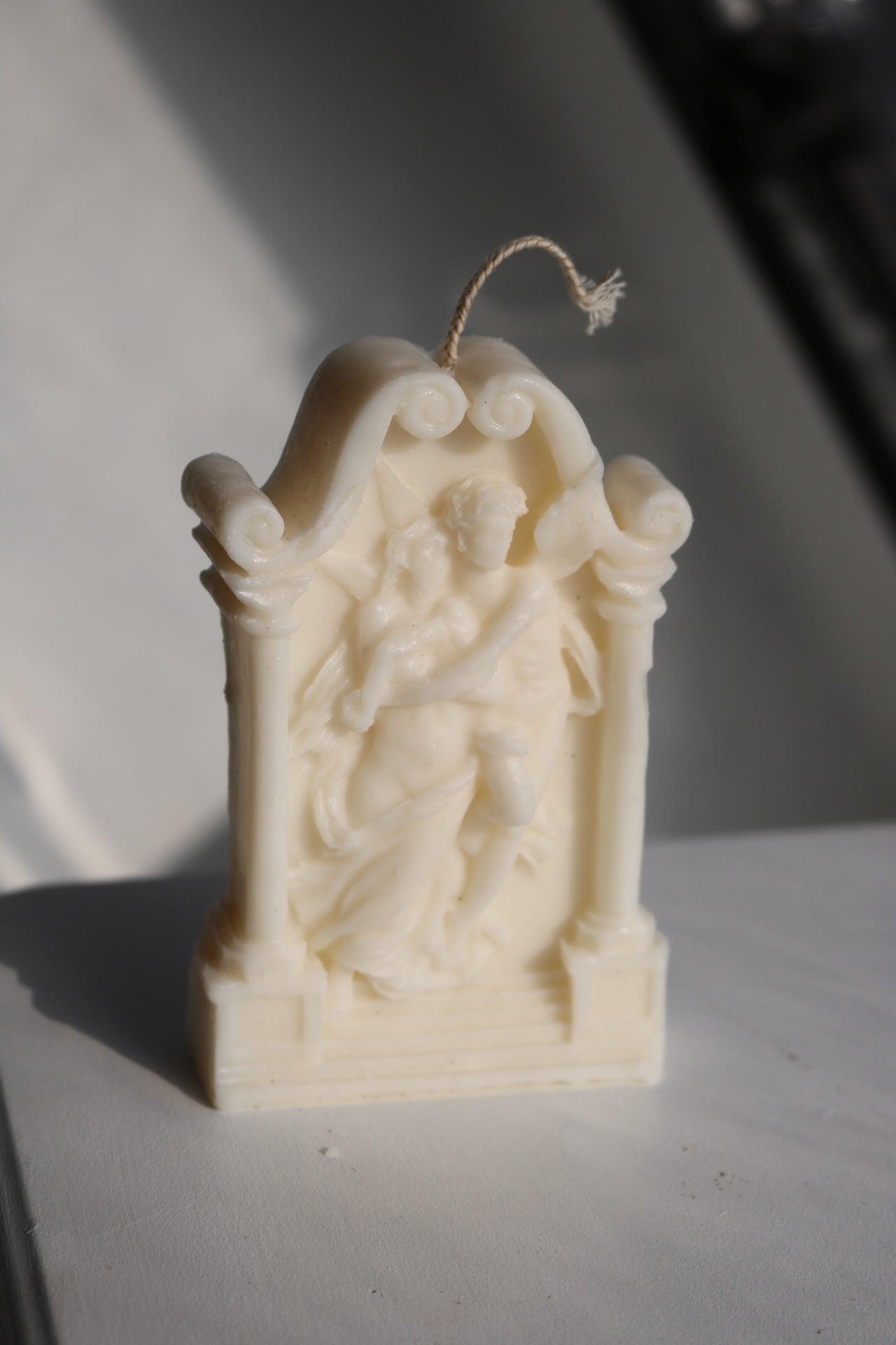A beautifully crafted Greek statue candle made from soy wax blend, showcasing intricate details and an elegant design.