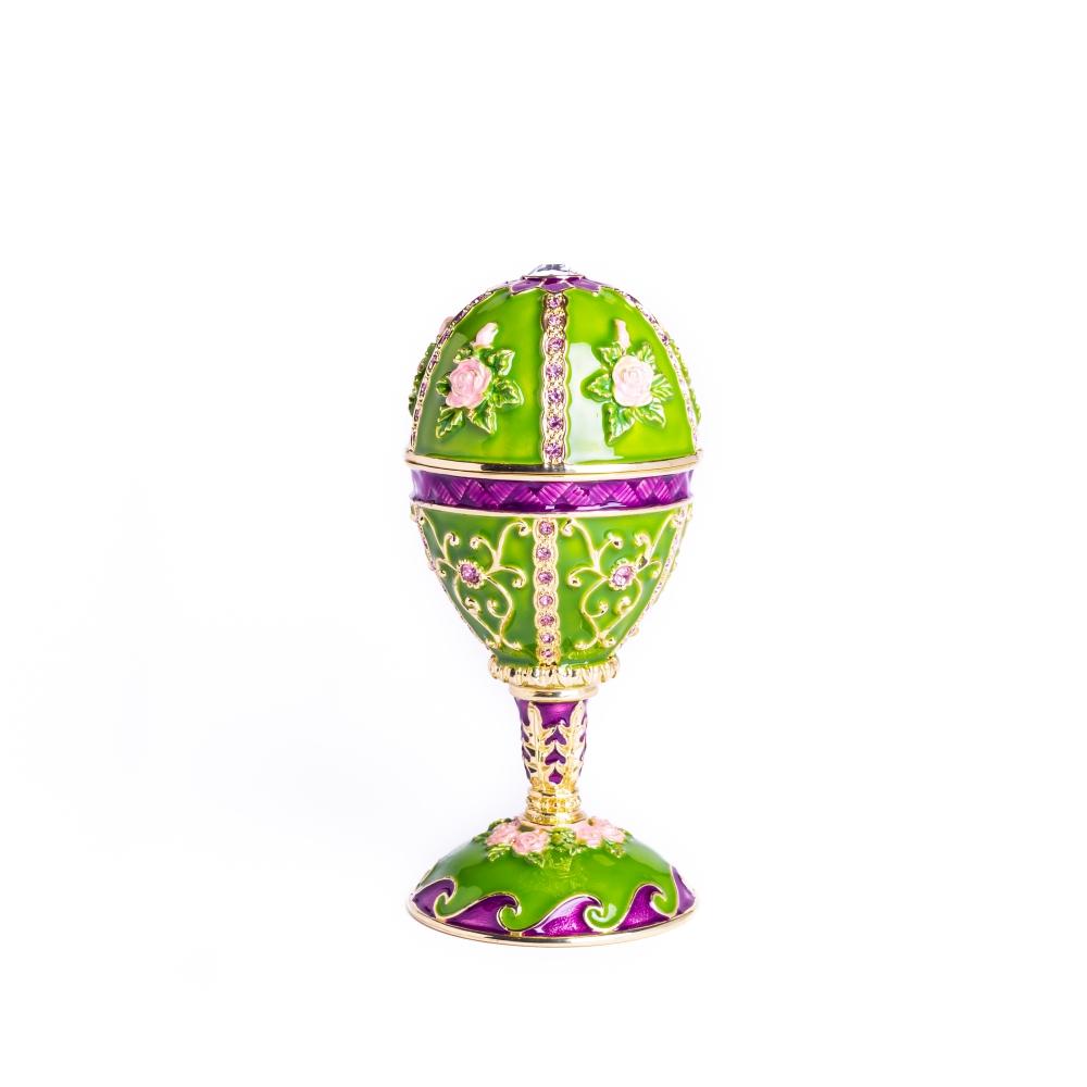 A stunning green Faberge egg trinket box adorned with flowers and Austrian crystals, featuring a 24K gold plating and a secure magnetic closure.