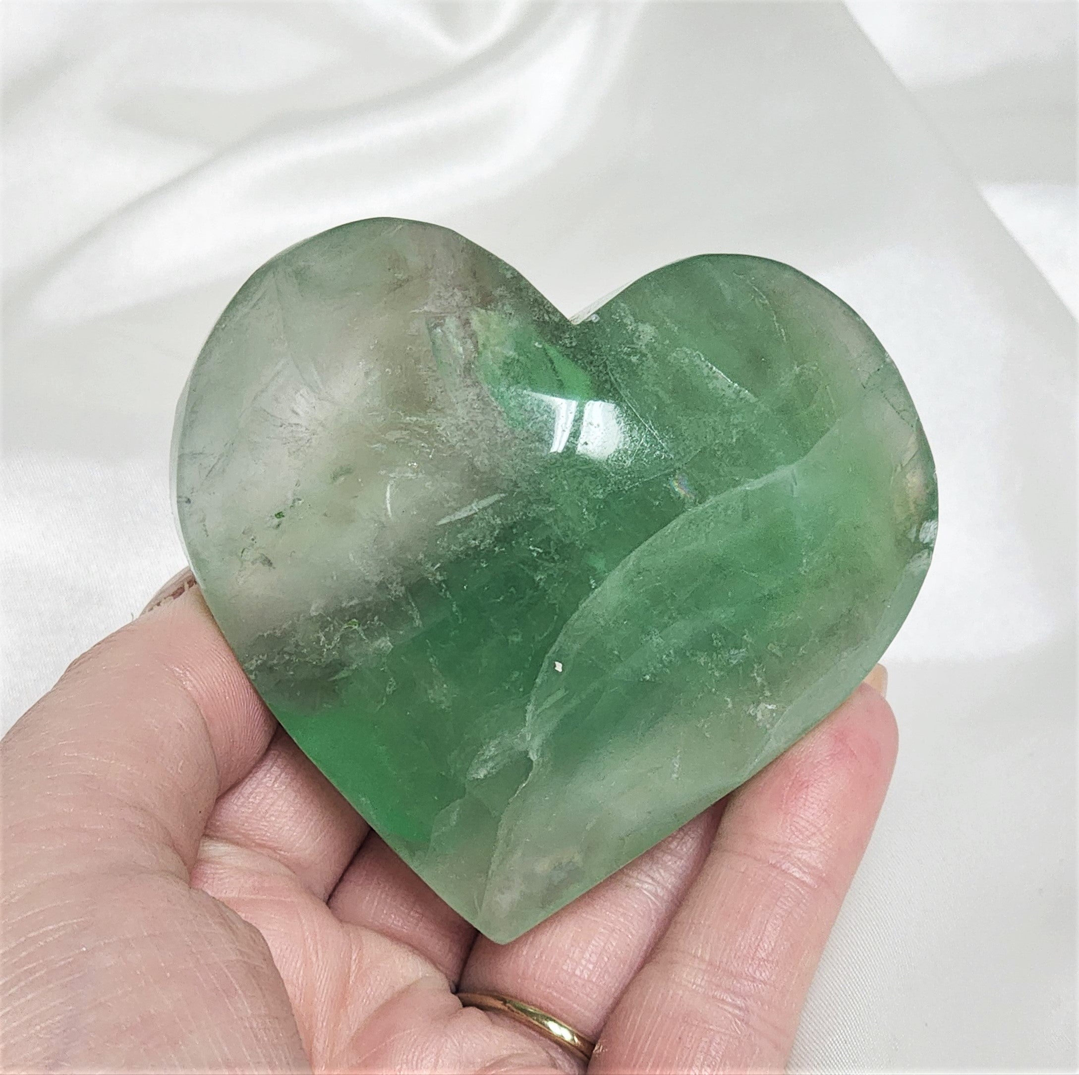 A beautifully polished Green Fluorite Heart showcasing its vibrant green hues and smooth surface, symbolizing healing and spiritual energy.