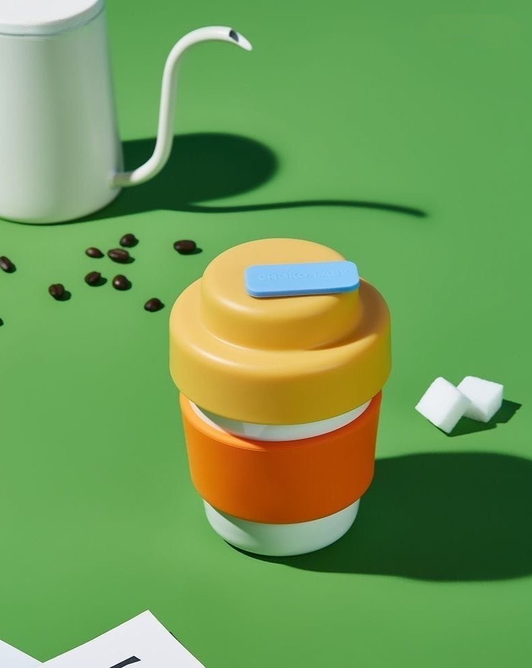 Gummies Thermos, a colorful vacuum insulated tumbler designed for coffee and tea, showcasing its sleek design and wide opening.