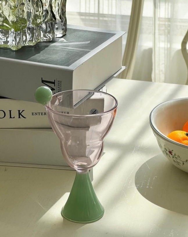 A set of colorful hand blown Bonbon Martini Glasses showcasing unique designs and vibrant colors, perfect for cocktails.