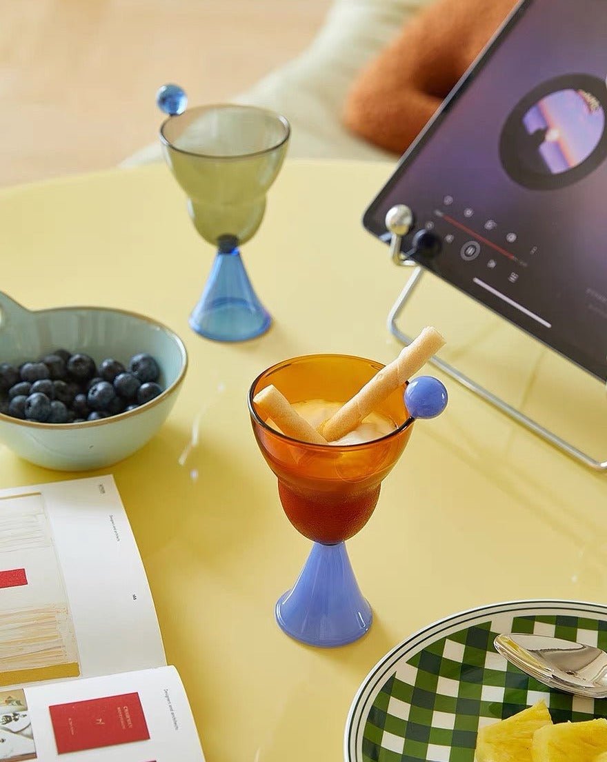 A set of colorful hand blown Bonbon Martini Glasses showcasing unique designs and vibrant colors, perfect for cocktails.