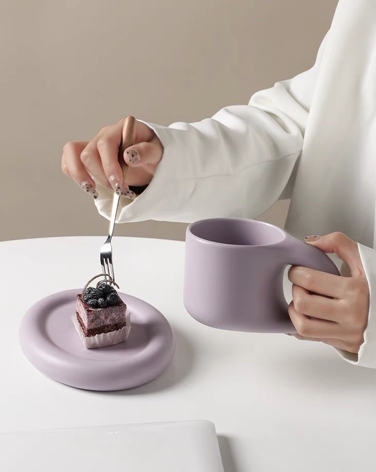 A set of handcrafted Bauhaus ceramic chubby mugs with smooth glaze and gentle curves, showcasing their unique design and craftsmanship.