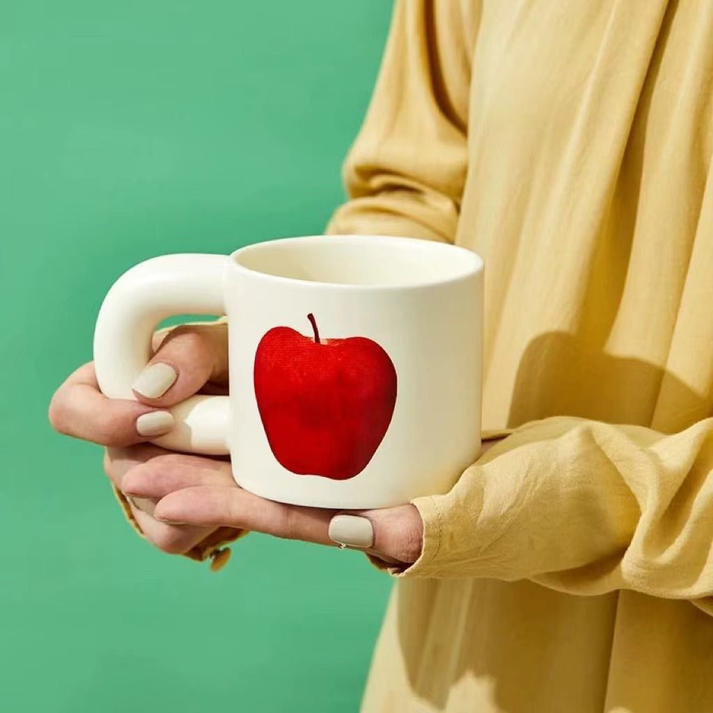 Handcrafted ceramic mugs featuring unique big apple and pear designs, perfect for coffee and tea lovers.