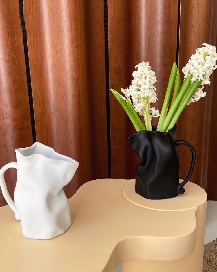 Handcrafted Nordic Style Wrinkle Pottery Jug Vase in black and white, showcasing its unique irregular shape and artisan craftsmanship.
