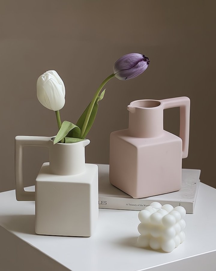 A unique handmade ceramic jug pitcher vase with a spout and handle, showcasing a modern minimalist design, perfect for decorative use.
