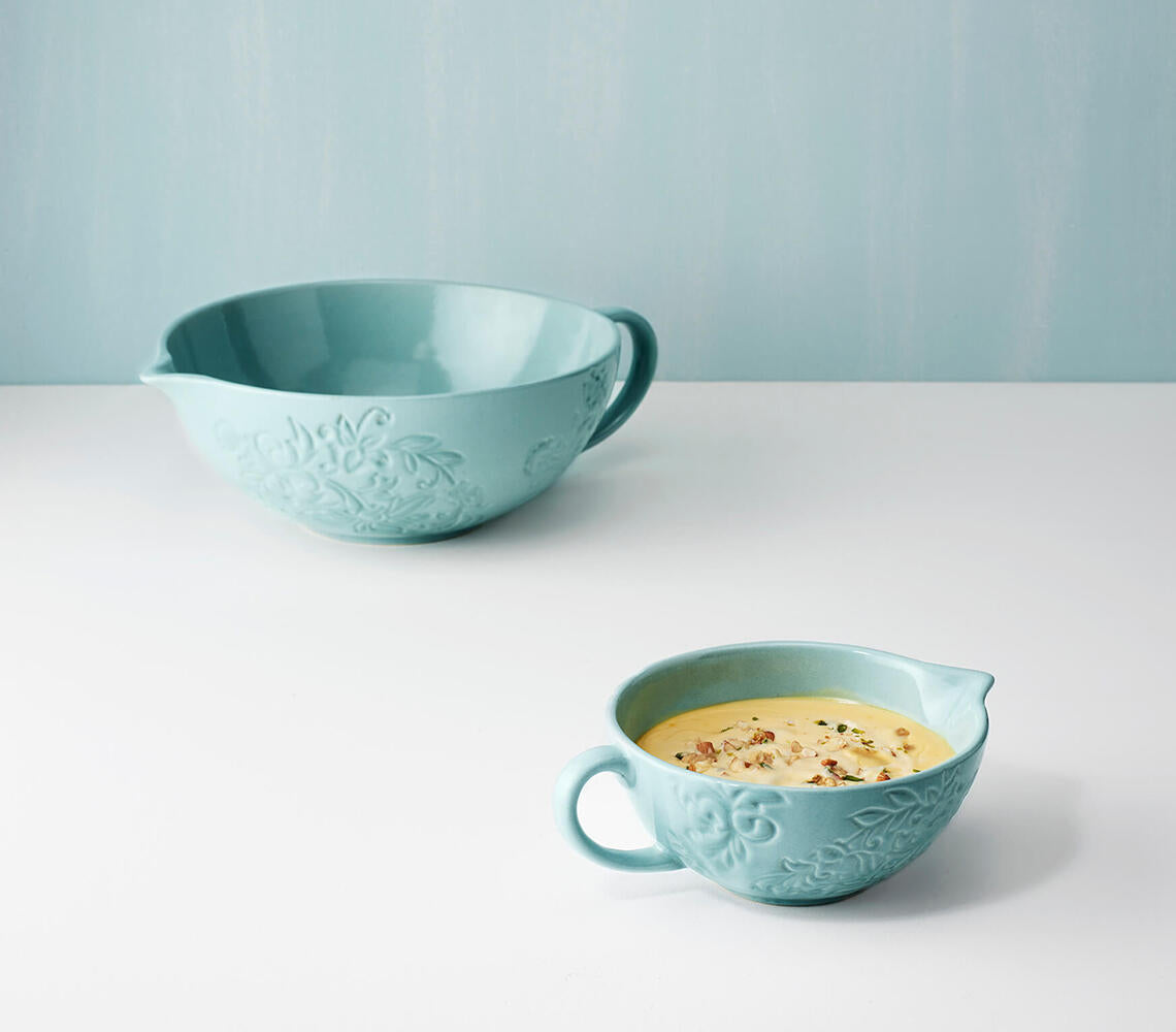A small handmade ceramic mixing bowl in blue, showcasing its unique glaze and artisanal craftsmanship.